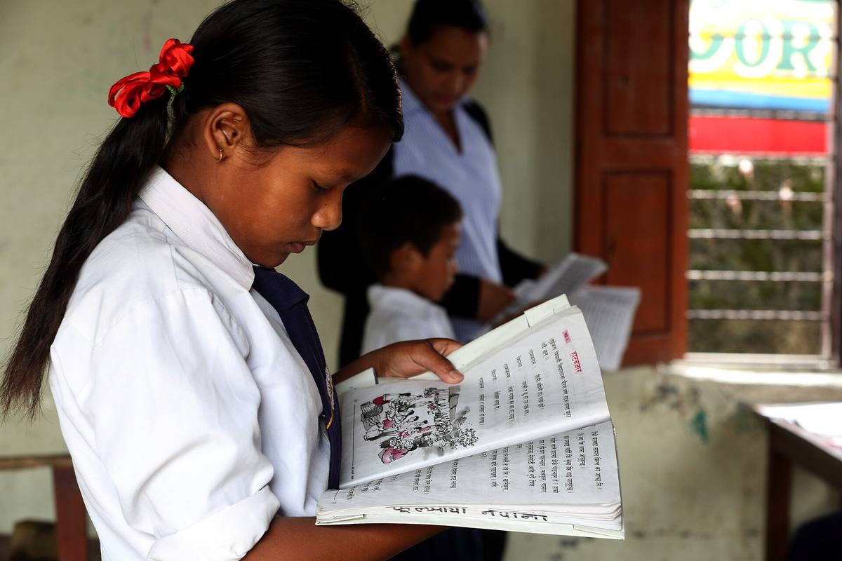 Student reads from a textbook at the Shree Sahara Bal Primary School, Pokhara, Nepal. Photo by Jim Holmes for AusAID. (13/2529)